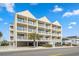 Inviting three-story condo with white balconies, covered parking, and a convenient beachside location at 4601 N Ocean Blvd. # 203, North Myrtle Beach, SC 29582