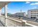 A street view featuring nearby buildings and glimpses of the ocean from a balcony at 4601 N Ocean Blvd. # 203, North Myrtle Beach, SC 29582