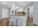 View of kitchen bar with granite countertops, seating, and an opening that views into the bunk room at 4601 N Ocean Blvd. # 203, North Myrtle Beach, SC 29582