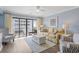 Sunlit living room offering a comfortable seating area, ceiling fan, and access to the balcony at 4601 N Ocean Blvd. # 203, North Myrtle Beach, SC 29582