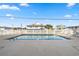 A community pool surrounded by a white fence and several chairs and tables at 4601 N Ocean Blvd. # 203, North Myrtle Beach, SC 29582