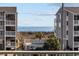 Exterior view showing beach access and a glimpse of the ocean at 4801 N Ocean Blvd. # 3E, North Myrtle Beach, SC 29582