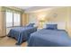 Cozy bedroom with two twin beds, window with blinds, and warm lighting for a comfortable stay at 5308 N Ocean Blvd. # 714, Myrtle Beach, SC 29577