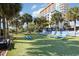 Outdoor lawn area with lounge chairs and green grass, with a view of palm trees and the condominium at 5308 N Ocean Blvd. # 714, Myrtle Beach, SC 29577