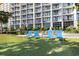 Lawn area with outdoor seating and blue sky in the background, in front of the beautiful condominium at 5308 N Ocean Blvd. # 714, Myrtle Beach, SC 29577