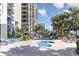 Inviting outdoor pool and whirlpool with lounge chairs and manicured landscaping under blue skies at the condominium at 5308 N Ocean Blvd. # 714, Myrtle Beach, SC 29577