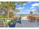 Backyard seating area with a pool and waterfront views on a sunny day at 534 South Creekside Dr., Murrells Inlet, SC 29576