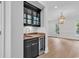 Stylish bar area with a mini-fridge, undermount sink, marble countertop, and ample storage at 534 South Creekside Dr., Murrells Inlet, SC 29576