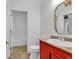 Unique bathroom with a red vanity, gold mirror, and adjacent toilet and shower area at 534 South Creekside Dr., Murrells Inlet, SC 29576