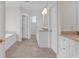 Well-lit bathroom featuring white cabinetry, neutral tile, soaking tub, and double sink at 534 South Creekside Dr., Murrells Inlet, SC 29576