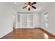 Spacious living room featuring a built-in bookcase, hardwood floors, and a ceiling fan at 534 South Creekside Dr., Murrells Inlet, SC 29576