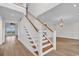 Elegant staircase with white railings and wooden steps, leading to the upper level at 534 South Creekside Dr., Murrells Inlet, SC 29576