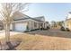 Inviting home exterior with brick accents, attached garage, and manicured landscaping in a quiet neighborhood at 537 Botany Loop # 537, Murrells Inlet, SC 29576