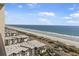 Aerial view of the beach and ocean, featuring a row of condos along the beach at 5523 N Ocean Blvd. # 1506, Myrtle Beach, SC 29577