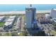 Scenic aerial view of an oceanfront condo building, showcasing nearby streets, parking, and beach access at 5523 N Ocean Blvd. # 1506, Myrtle Beach, SC 29577