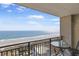 Balcony with a table and chairs overlooking the beach and ocean at 5523 N Ocean Blvd. # 1506, Myrtle Beach, SC 29577