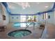 Relaxing indoor pool area with a connecting hot tub, seating, and large windows for natural light at 5523 N Ocean Blvd. # 1506, Myrtle Beach, SC 29577