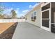 Backyard with a screened-in porch and a concrete patio at 591 Meadowgrass Ct., Myrtle Beach, SC 29588