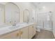 Bright bathroom with dual sink vanity, large mirrors, and walk-in shower at 591 Meadowgrass Ct., Myrtle Beach, SC 29588