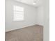 Neutral bedroom with plush carpeting, a window for natural light, and clean, white walls at 591 Meadowgrass Ct., Myrtle Beach, SC 29588