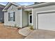 Close-up of home's entry; features well-kept landscaping, two-car garage, and easy access walkway at 591 Meadowgrass Ct., Myrtle Beach, SC 29588