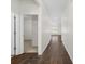 Inviting hallway featuring hardwood floors and white trim, leading to various rooms at 591 Meadowgrass Ct., Myrtle Beach, SC 29588