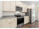 Kitchen with granite countertops, tile backsplash, stainless steel appliances, and cream cabinets at 591 Meadowgrass Ct., Myrtle Beach, SC 29588