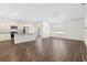 Open-concept living room showcasing hardwood floors, modern lighting, and connected kitchen area at 591 Meadowgrass Ct., Myrtle Beach, SC 29588