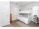 Bedroom with white painted walls and ceiling fan, features a bunk bed, rug and side table at 601 Hillside Dr. N # 1731, North Myrtle Beach, SC 29582