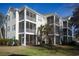 View of the rear exterior of the condo building with private screened in porches at 601 Hillside Dr. N # 1731, North Myrtle Beach, SC 29582