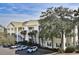 Inviting three-story condo with private patios, palm trees, and convenient parking at 601 Hillside Dr. N # 1731, North Myrtle Beach, SC 29582