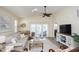 Bright living room with neutral tones, a ceiling fan, and sliding glass doors to a screened balcony at 601 Hillside Dr. N # 1731, North Myrtle Beach, SC 29582