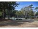 Tennis court surrounded by mature trees and lush green space, perfect for outdoor activities at 601 Hillside Dr. N # 1731, North Myrtle Beach, SC 29582