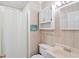 This bathroom features a toilet, sink, vanity, cabinet, towel rack, and a shower with a white shower curtain at 613 South Ocean Blvd. # O-2, North Myrtle Beach, SC 29582