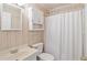 Traditional bathroom with white fixtures, vanity, mirror, and shower with curtain at 613 South Ocean Blvd. # O-2, North Myrtle Beach, SC 29582