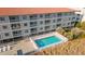 An aerial view of the pool and deck area, showing a white picket fence and nearby ocean access at 613 South Ocean Blvd. # O-2, North Myrtle Beach, SC 29582