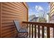 Balcony showcasing a chair overlooking greenery, with neighboring residences under a sunny, blue sky at 617 S 13Th Ave. # 116, Surfside Beach, SC 29575