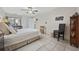 Sunlit bedroom features tile floors, closet space, a work desk and neutral decor, creating a cozy retreat at 617 S 13Th Ave. # 116, Surfside Beach, SC 29575