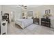 Bright bedroom featuring tile flooring, a ceiling fan, closet, and neutral decor, creating a cozy atmosphere at 617 S 13Th Ave. # 116, Surfside Beach, SC 29575