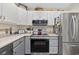 Well-lit kitchen with stainless steel appliances and gray cabinets provides a modern, functional cooking space at 617 S 13Th Ave. # 116, Surfside Beach, SC 29575