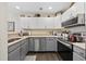 Modern kitchen featuring stainless steel appliances, white cabinets, and wood flooring at 617 S 13Th Ave. # 116, Surfside Beach, SC 29575