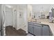 Functional kitchen area with double sink, neutral countertops and cabinets, and hardwood flooring at 617 S 13Th Ave. # 116, Surfside Beach, SC 29575