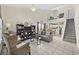 Bright living room featuring tile floors, vaulted ceiling, and staircase leading to the open loft at 617 S 13Th Ave. # 116, Surfside Beach, SC 29575