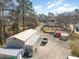 Aerial view of a home and outbuildings on a large wooded lot with a long driveway and mature trees at 639 Blackstone Dr., Myrtle Beach, SC 29588