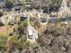 Aerial view of a property with a home, outbuildings, sheds, and ample land, offering potential for various uses at 639 Blackstone Dr., Myrtle Beach, SC 29588