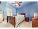 Comfortable bedroom with a ceiling fan, a dark blue accent wall, and decorative accents throughout at 639 Blackstone Dr., Myrtle Beach, SC 29588