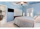 Comfortable bedroom featuring light blue walls, ceiling fan, television, and a closet at 639 Blackstone Dr., Myrtle Beach, SC 29588