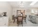 Bright dining area with a table set for four, open to the kitchen, and with modern light fixtures at 639 Blackstone Dr., Myrtle Beach, SC 29588