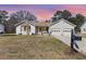 Charming single-story home with a two-car garage, well-manicured lawn, and inviting front porch, exuding curb appeal at 639 Blackstone Dr., Myrtle Beach, SC 29588