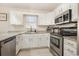 Bright kitchen featuring stainless steel appliances, granite countertops, and white cabinetry at 639 Blackstone Dr., Myrtle Beach, SC 29588